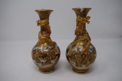null 
Pair of satsuma vase decorated with characters, decorated in relief with dragons...
