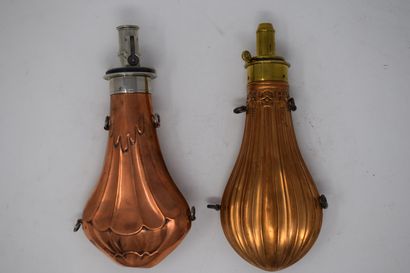 null Two embossed copper powder flasks and brass dispenser:

- decoration of a hot-air...