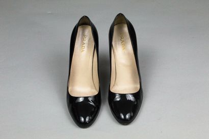  PRADA 
 
Pair of black patent leather pumps with round toes. 
Wear on one of the...