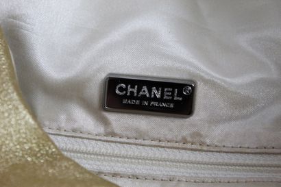null CHANEL 

Gold leather duffel bag carried by hand or shoulder. 

Iridescent satin...