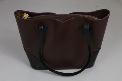 null CHRISTIAN LACROIX 

Brown leather and black glazed leather bag. 

Heart and...