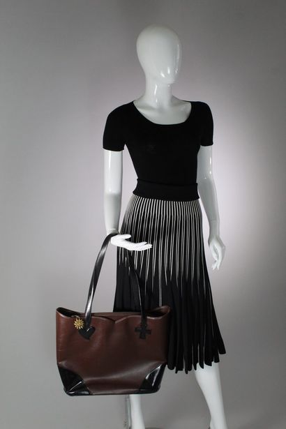 null CHRISTIAN LACROIX 

Brown leather and black glazed leather bag. 

Heart and...