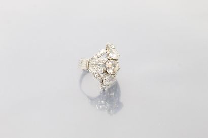 null A platinum ring set with a line of falling brilliant-cut diamonds, shouldered...