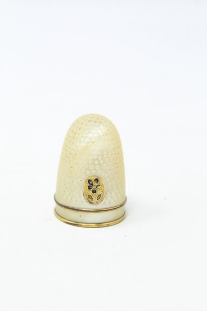 Mother-of-pearl thimble encircled by two...