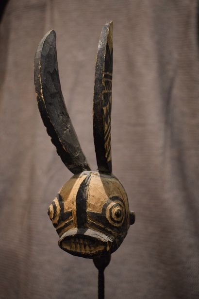 null Carved and painted wooden animal head representing a water god.

on a high metal...