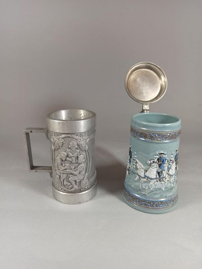 null Set of 2 beer mugs, one in metal with carved decoration of a tavern scene in...