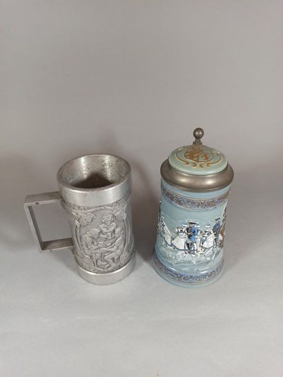 null Set of 2 beer mugs, one in metal with carved decoration of a tavern scene in...