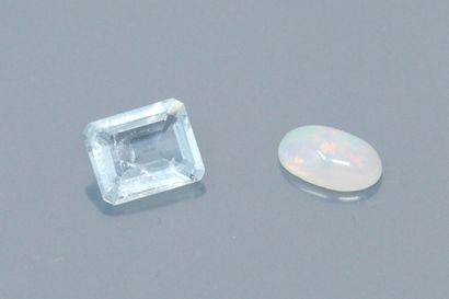 null Lot comprising a cabochon opal and a rectagular aquamarine with cut sides on...
