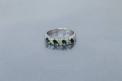 null 
Wedding ring in 14k (585) white gold set with four emeralds and three navette...