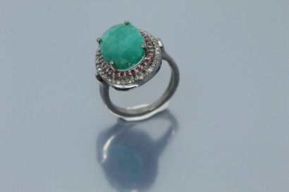 null Silver ring set with an oval emerald in a double surround of diamonds and rubies

Weight...