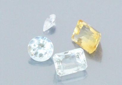 null Lot of four stones on paper with a white stone, two aquamarines and a citrine....