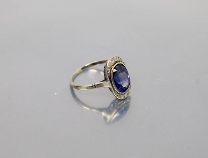 null Oblong ring set with an oval synthetic sapphire and diamonds. 

Finger size...