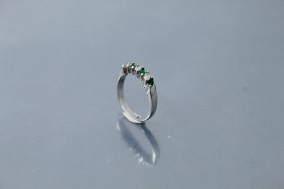 null 
Wedding ring in 14k (585) white gold set with four emeralds and three navette...