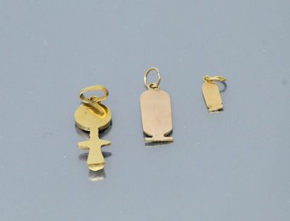 null Two 18k (750) yellow gold pendants, one with an Egyptian motif and one featuring...