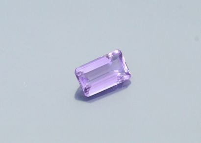 null Rectangular amethyst with cut sides on paper. 

Weight : 19.22 cts.