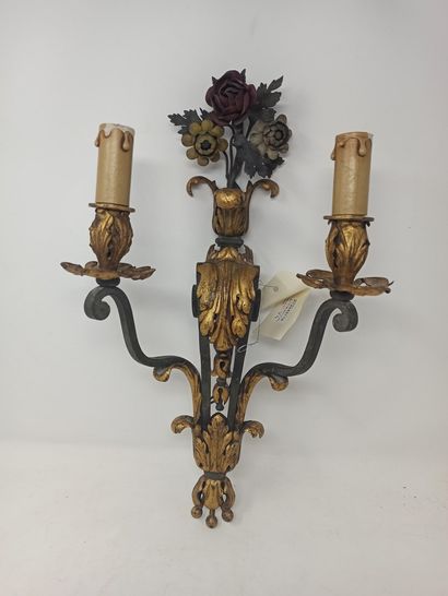 null Suite of four two-light sconces, in wrought iron with partially gilded decoration...