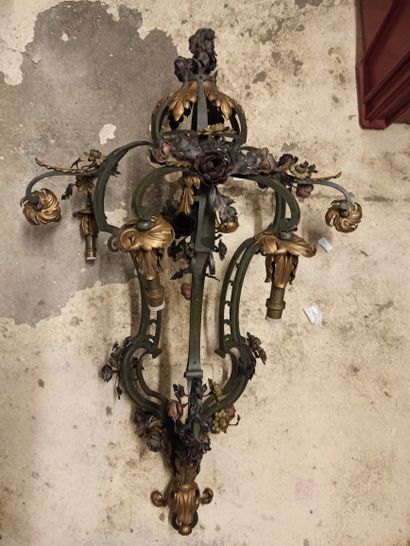null 
Three branches and six lights chandelier, in wrought iron with partially gilded...
