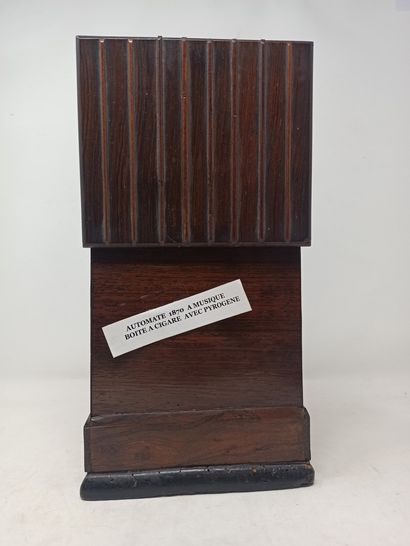 null Rare automaton cigar box in wood and music. It presents on its front side a...
