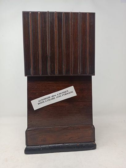 null Rare automaton cigar box in wood and music. It presents on its front side a...