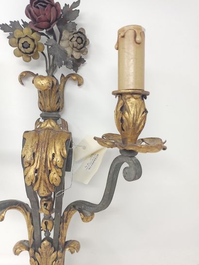 null Suite of four two-light sconces, in wrought iron with partially gilded decoration...