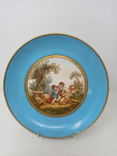 null A slightly hollow plate decorated with two children playing with a dog on a...