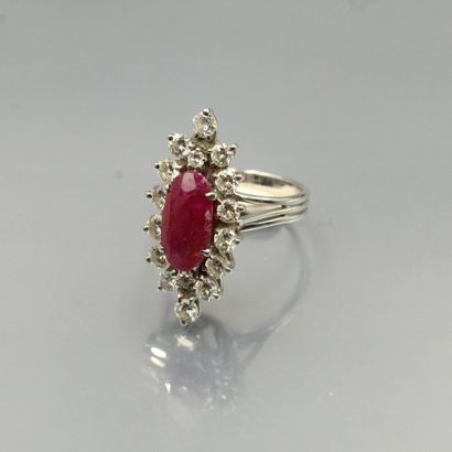 null An 18K (750) gold marquise ring set with an oval ruby and brilliant-cut diamonds.

Hallmarked...