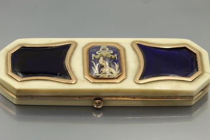 null An octagonal ivory and gold box, the hinged lid decorated on a blue enamelled...