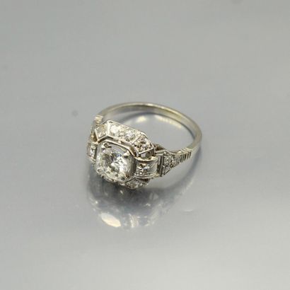 null Octagonal platinum ring set with an old-cut diamond, shouldered and surrounded...