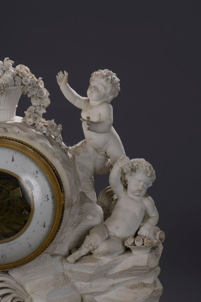 null Bisque clock 

figuring a rock decorated with foliage topped by a basket of...