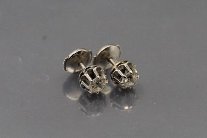 null Pair of 18k (750) white gold and old cut diamonds studs. 

Marked with an eagle's...