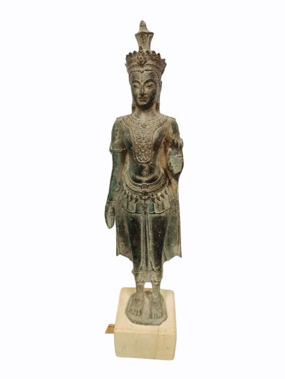 Bronze Buddha shown standing and making the...