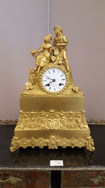 null Gilt bronze clock surmounted by a group representing a gallant couple, 

the...