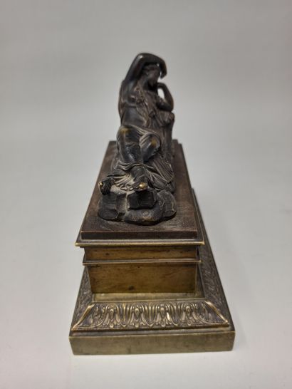 null 
Rectangular inkwell in gilt metal, the lid surmounted by a reclining woman...