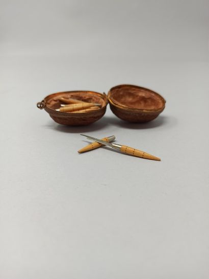 null Walnut shell forming a pendant (metal frame), made in Nontron (Dordogne), containing...