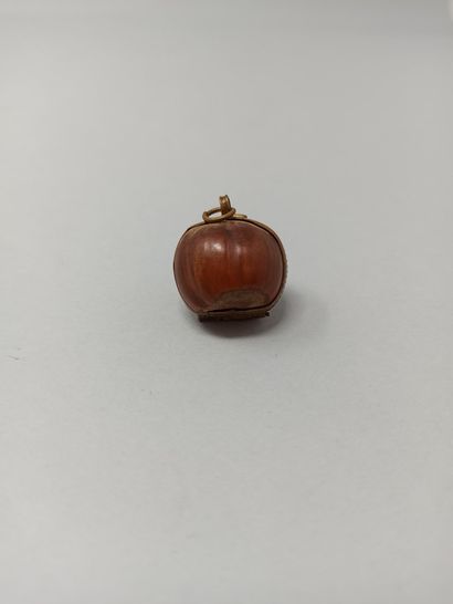null Hazelnut shell forming a pendant (metal frame), made in Nontron (Dordogne),...