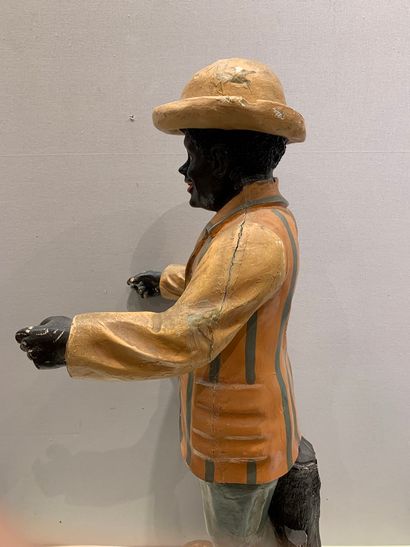 null Sculpture en résine figurant un homme de couleur en chapeau melon et veste rayée

manques...