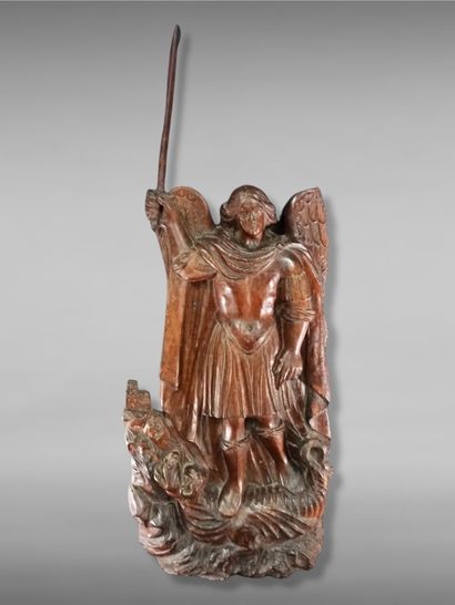 Saint Michael in walnut carved in high relief....