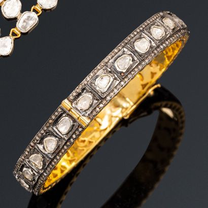 Opening bracelet in silver gilt, set with...