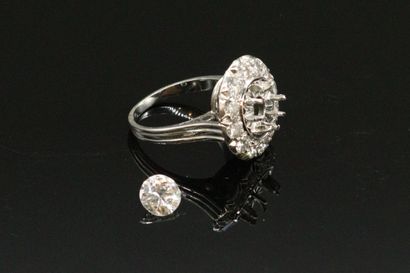 null 18K (750) white gold and platinum ring set with a round half-cut diamond weighing...