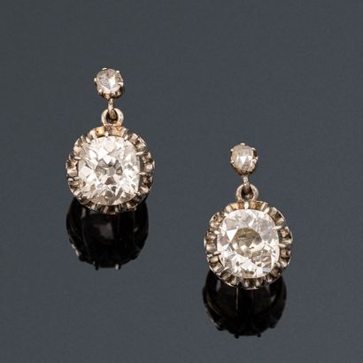 null A pair of 18K (750) silver and gold sleeper earrings, each set with an old-cut...
