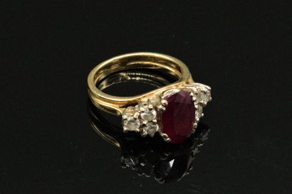 null Bague en or 18K (750), ornée d'un rubis de forme ovale épaulé de 6 diamants...
