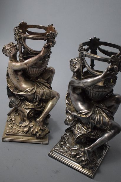 null Two silvered bronze cups; featuring a draped woman in the antique style sitting...