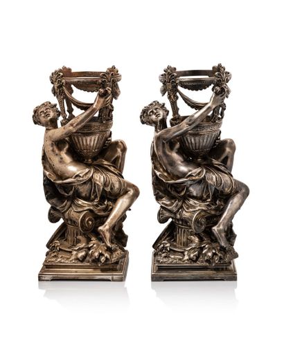 null Two silvered bronze cups; featuring a draped woman in the antique style sitting...