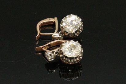 null A pair of 18K (750) silver and gold sleeper earrings, each set with an old-cut...