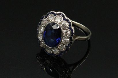 null 18K (750) white gold ring, set with a synthetic sapphire surrounded by round...