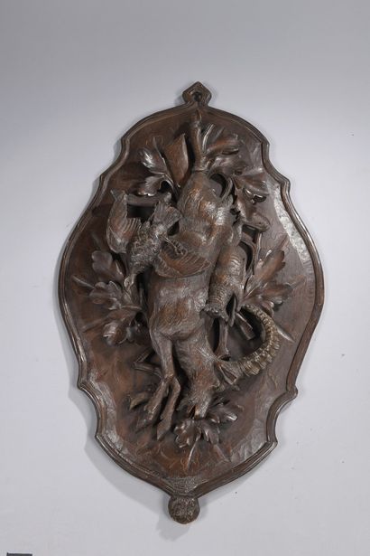 null Suite of three medallions in wood carved in high relief of animal trophies,...