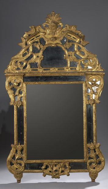 Mirror with parecloses in carved and gilded...