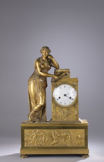 null Gilt bronze clock with a high rectangular base decorated with a relief depicting...