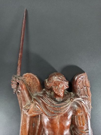 null Saint Michael in walnut carved in high relief. Standing on the dragon, the archangel...