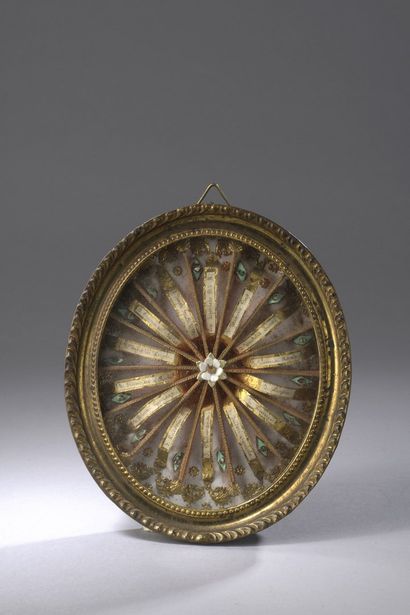 Reliquary with paperolles of oval form with...